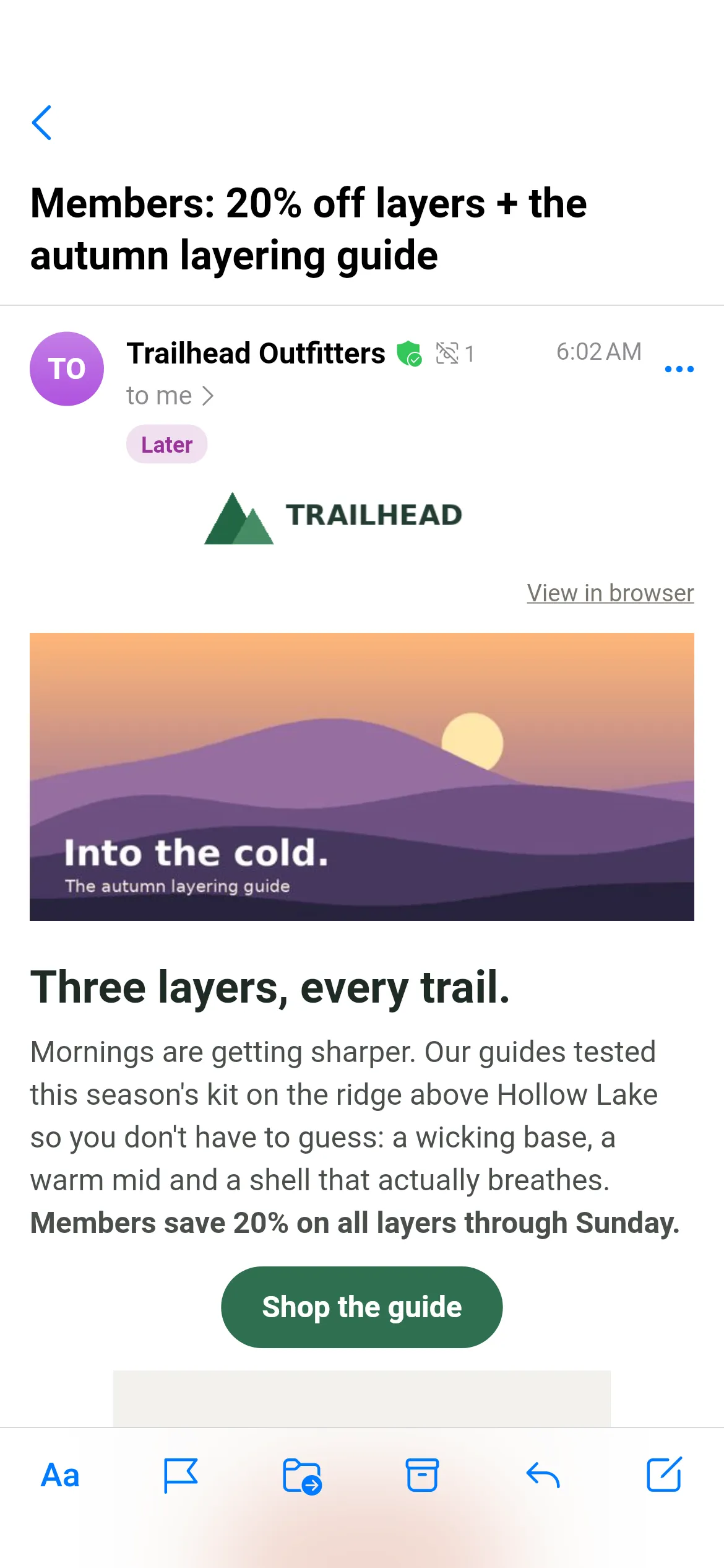 A Trailhead Outfitters newsletter, “Members: 20% off layers + the autumn layering guide”, open in Readable mode: a green verified-sender shield and a tracker count of 1 beside the sender, a purple Later tag, the Trailhead logo, a sunset hero image captioned “Into the cold.”, the heading “Three layers, every trail.”, body text and a green Shop the guide button. The reading toolbar sits at the bottom.